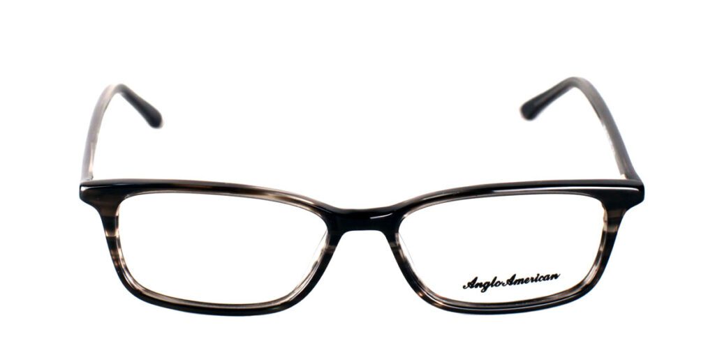 A pair of glasses is shown with the reflection of the lens.