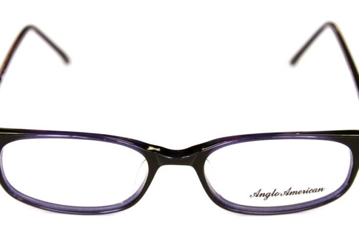 A pair of glasses with purple frames and black rims.