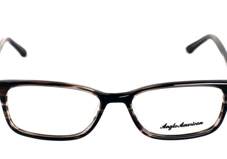 A pair of glasses is shown with the reflection of the lens.