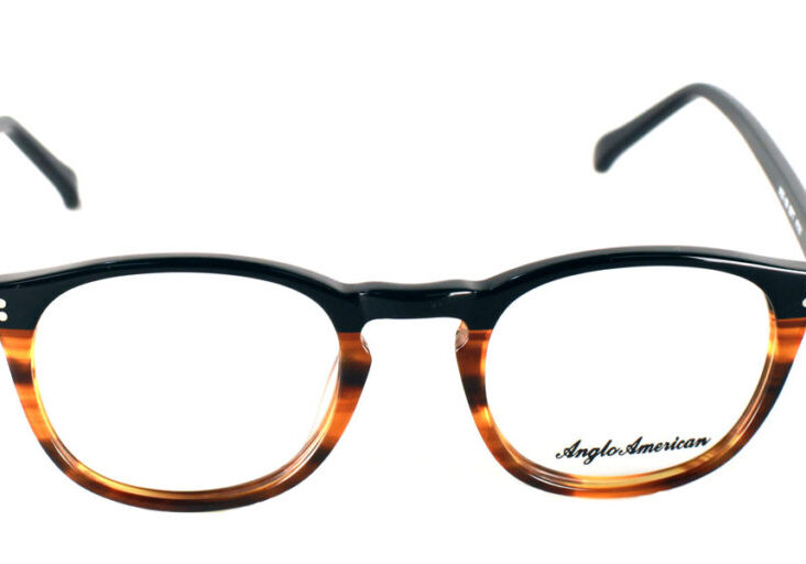 A pair of glasses is shown with the frame in focus.